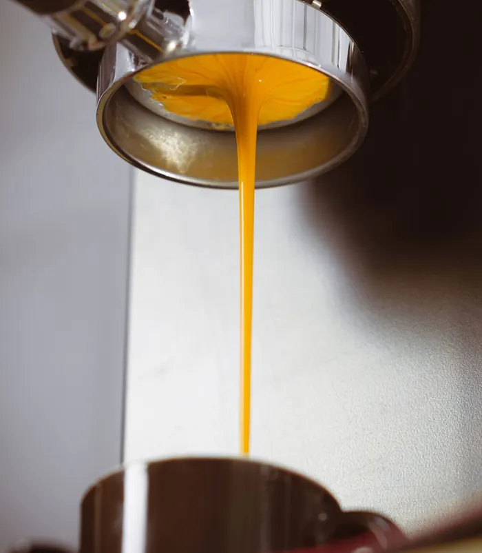 Espresso forming a single centered cone under a bottomless basket